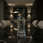 Clear glass tableware on a wooden stand with blurred background, featuring the brand 'Azad'.